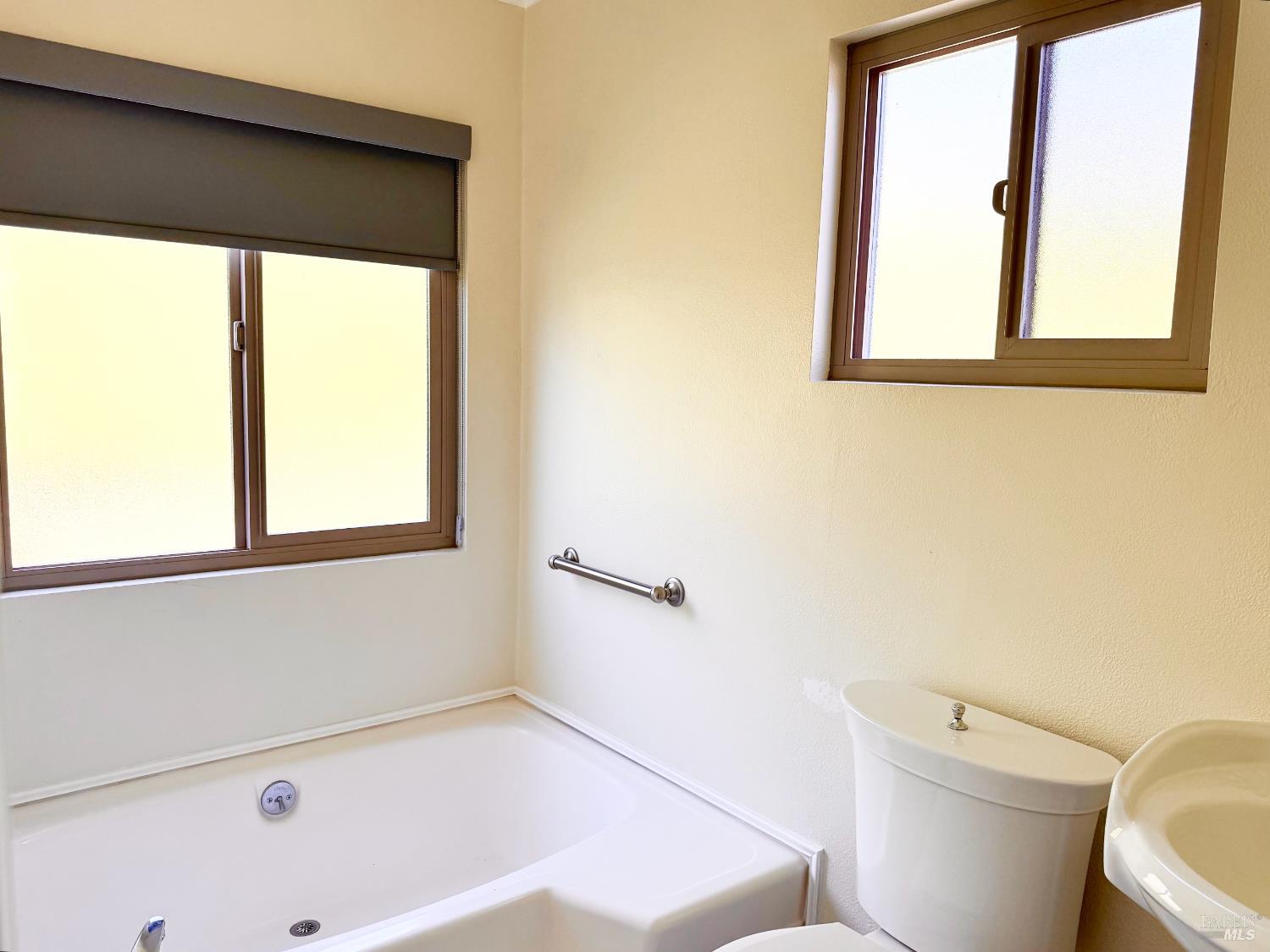 1945 Piner Road, Unit 16 Santa Rosa, CA 95403 - Photo 15 of 21 a bathroom with a bathtub and a window