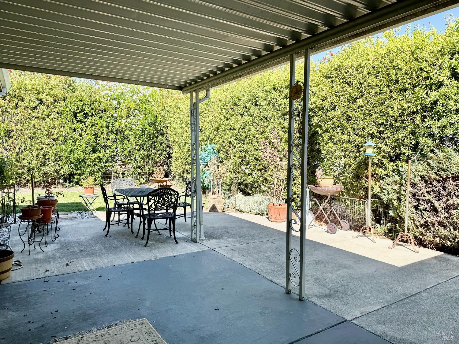 1945 Piner Road, Unit 16 Santa Rosa, CA 95403 - Photo 17 of 21 a view of a patio with table and chairs and floor to ceiling window