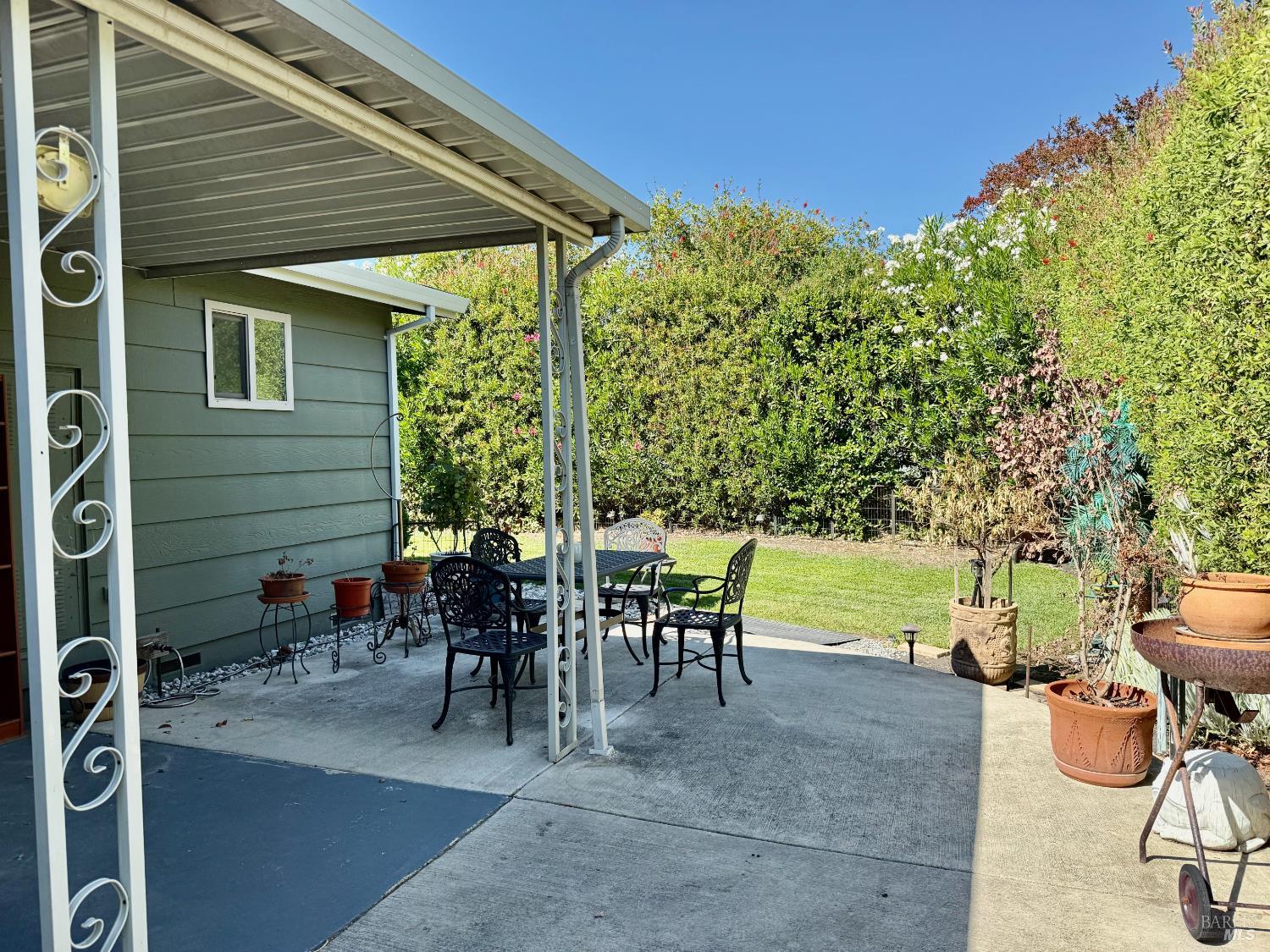 1945 Piner Road, Unit 16 Santa Rosa, CA 95403 - Photo 21 of 21 a view of a patio with table and chairs potted plants and palm tree
