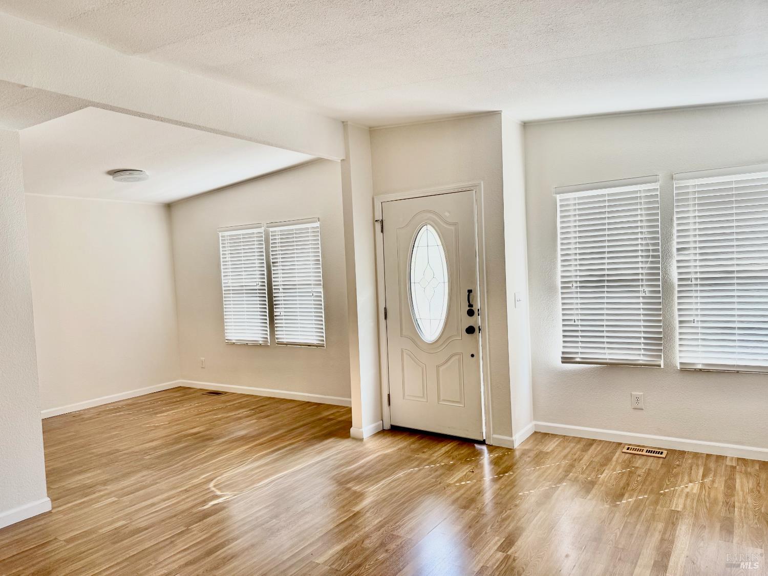 1945 Piner Road, Unit 16 Santa Rosa, CA 95403 - Photo 4 of 21 a view of a room with wooden floor and white walls