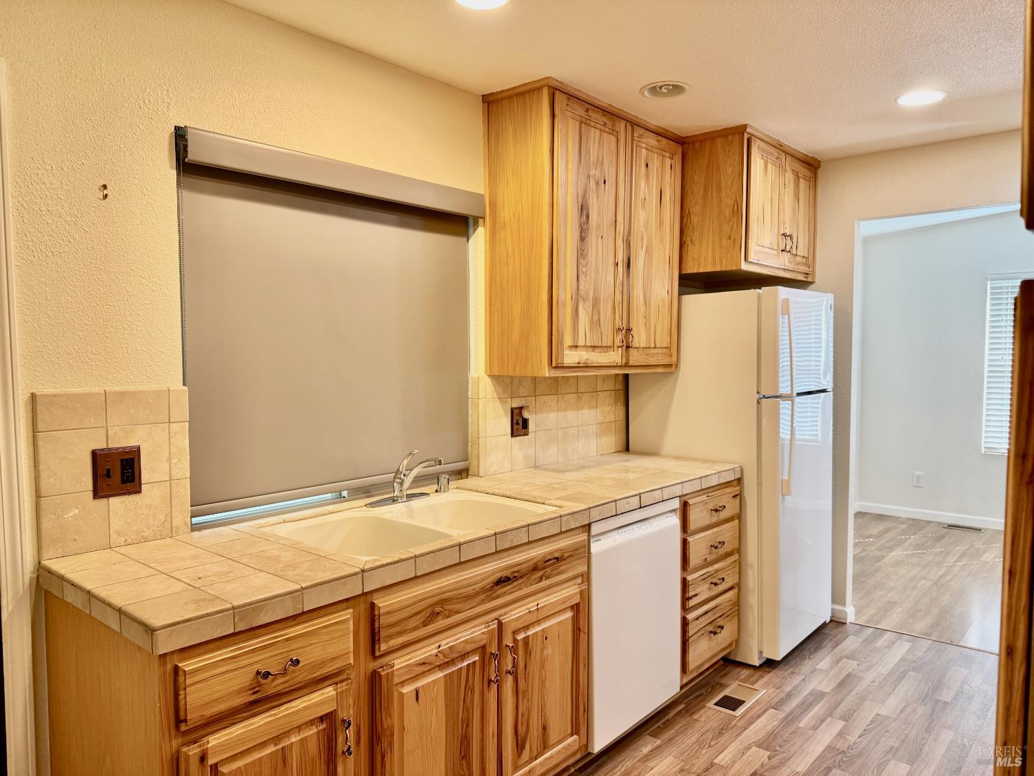 1945 Piner Road, Unit 16 Santa Rosa, CA 95403 - Photo 10 of 21 a kitchen with stainless steel appliances granite countertop a refrigerator and a stove