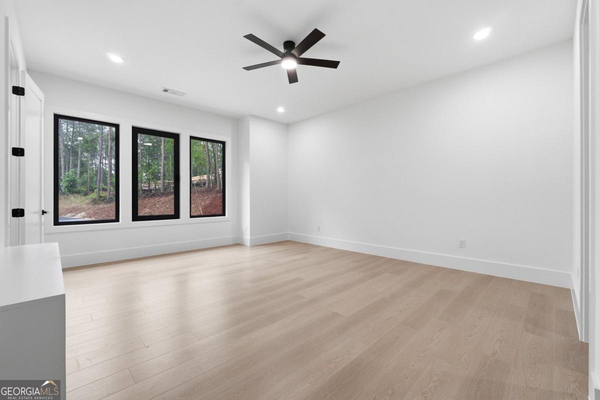 1563 Whitley Road Bethlehem, GA 30620 - Photo 26 of 44 an empty room with windows and ceiling fan