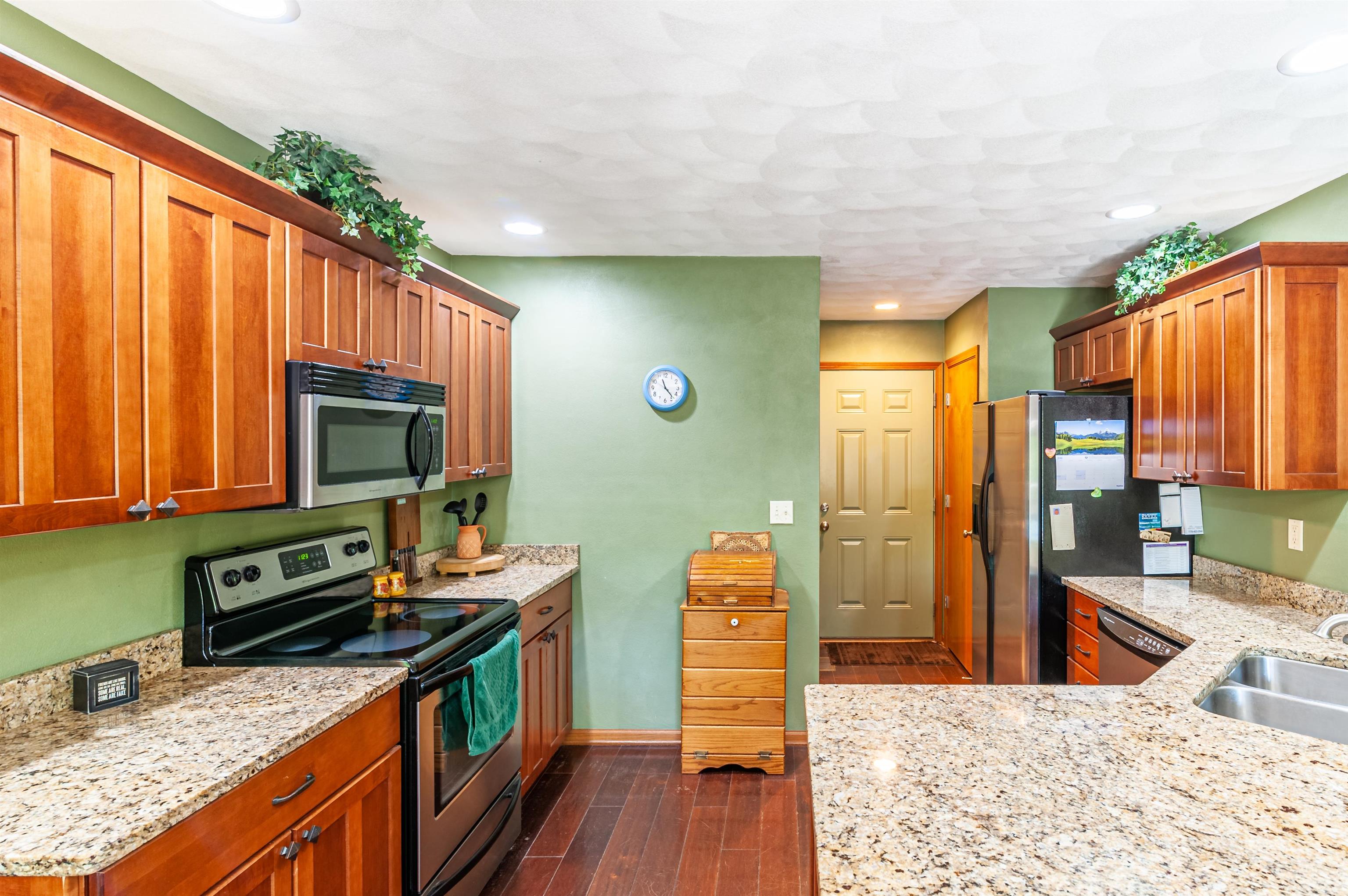 709 North Alpine Road Rockford, IL 61107 - Photo 18 of 47 a kitchen with stainless steel appliances granite countertop a refrigerator a stove a sink dishwasher and wooden cabinets with wooden floor