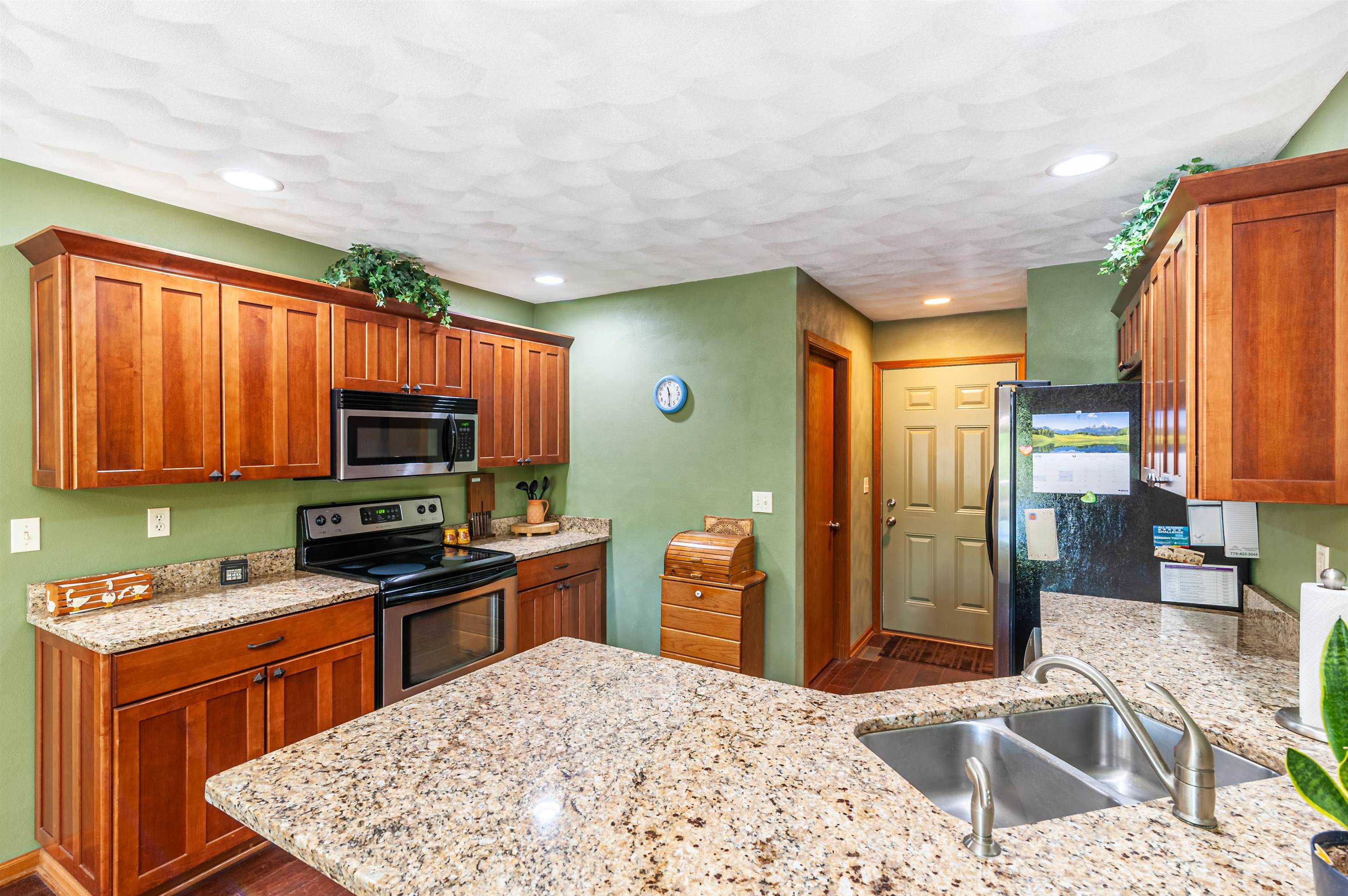 709 North Alpine Road Rockford, IL 61107 - Photo 20 of 47 a kitchen with stainless steel appliances granite countertop a sink stove and refrigerator