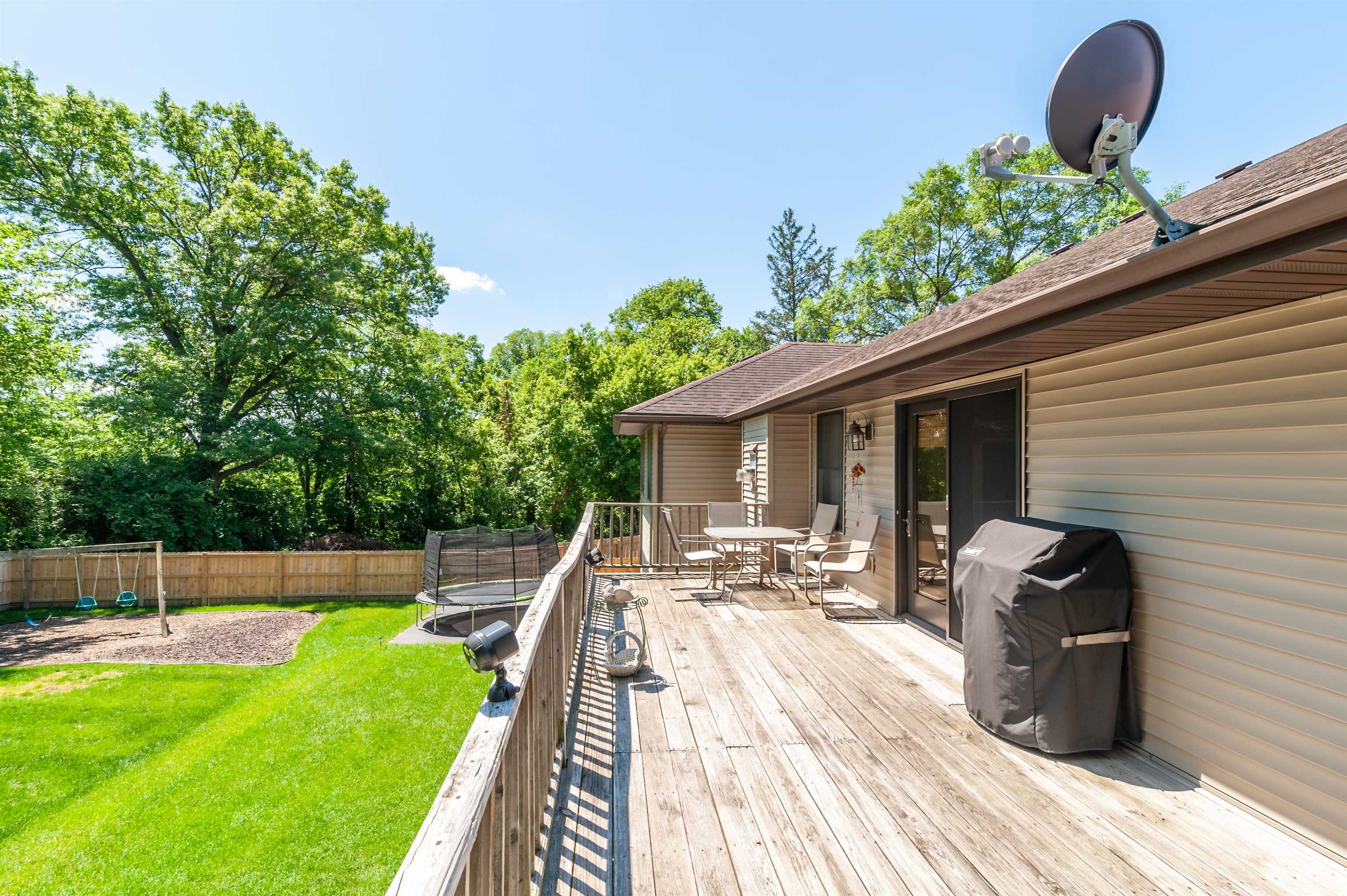 709 North Alpine Road Rockford, IL 61107 - Photo 44 of 47 a view of a backyard with couches chair and wooden fence