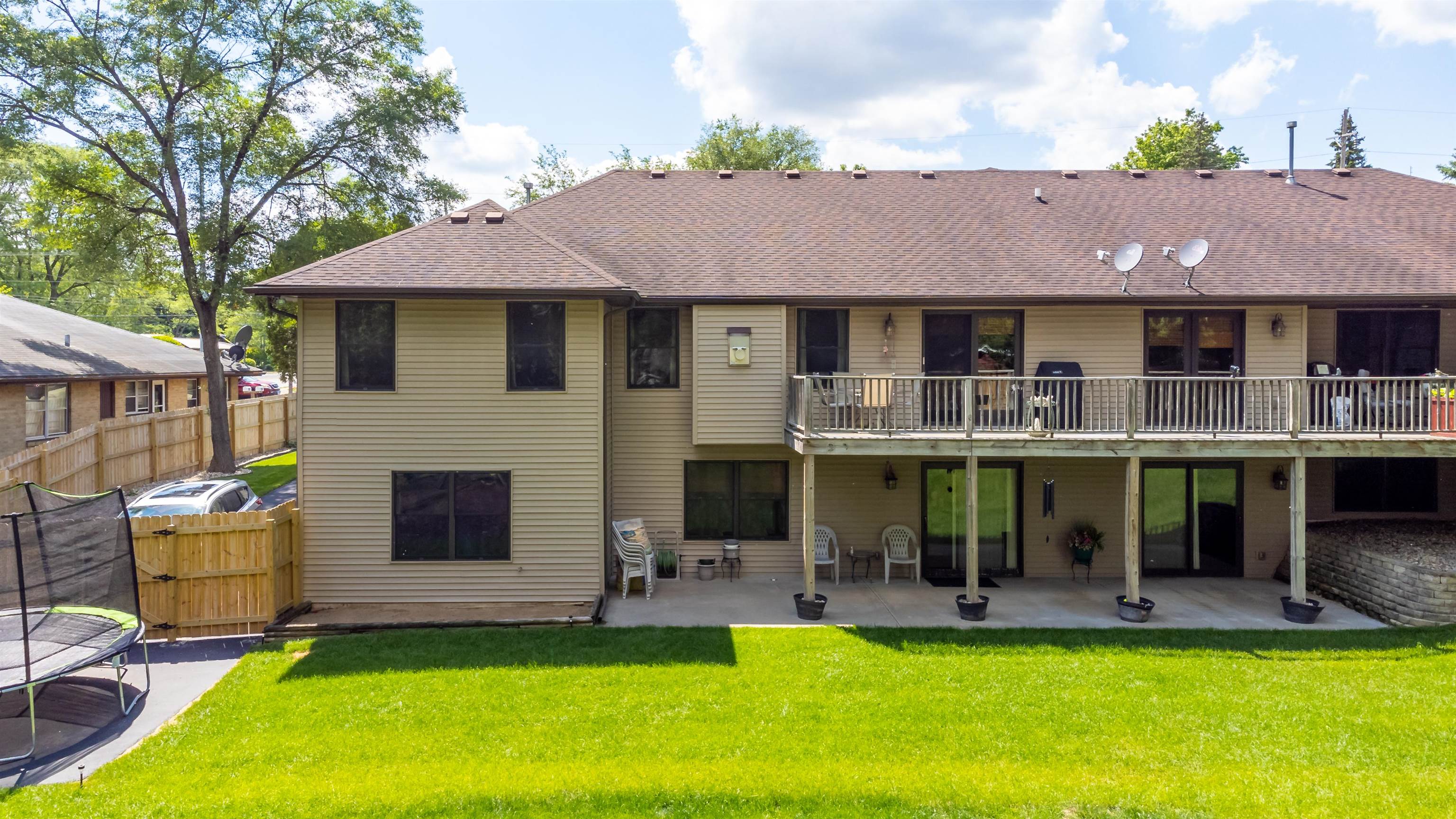 709 North Alpine Road Rockford, IL 61107 - Photo 6 of 47 a view of a white house with a swimming pool and a yard