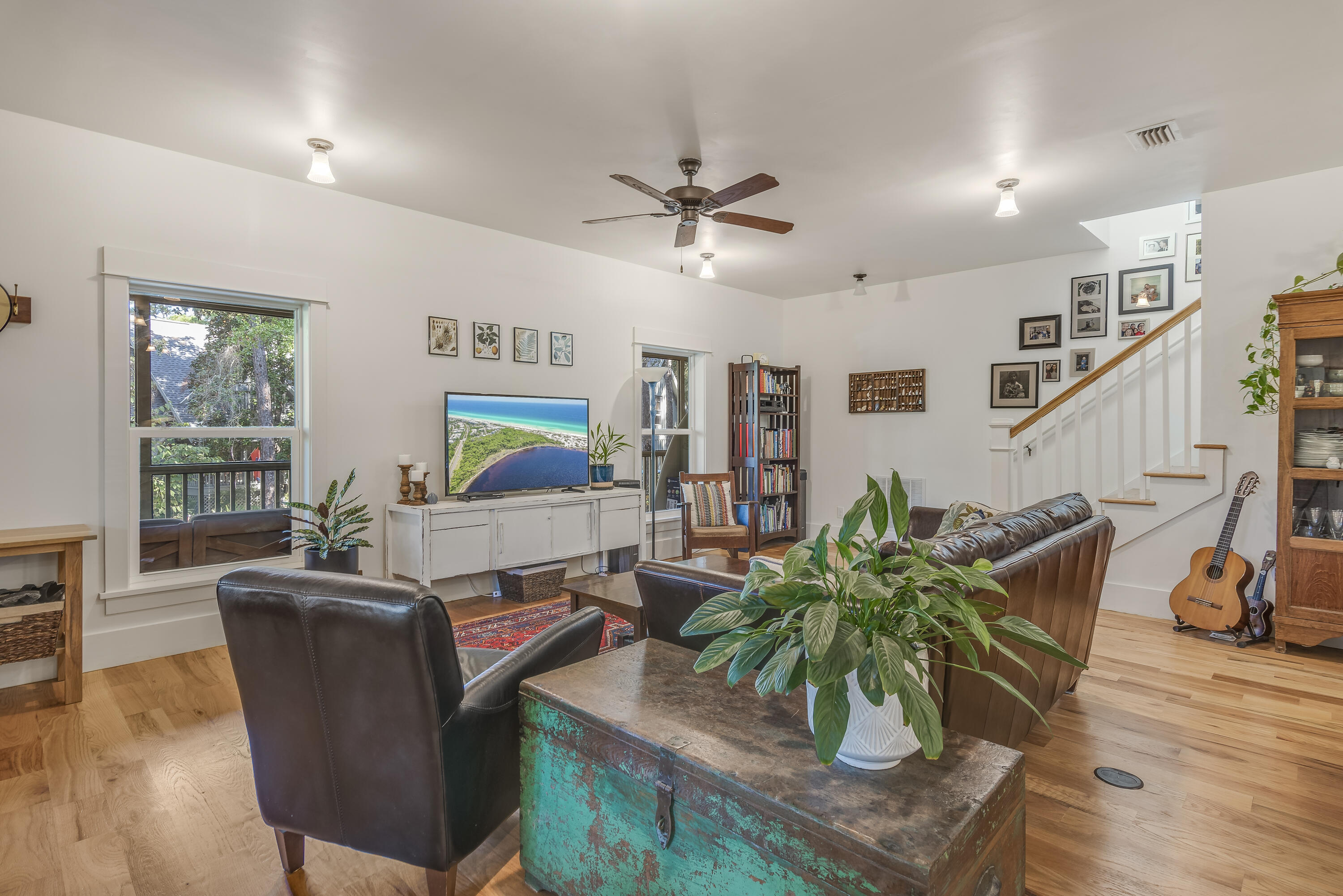 a living room with furniture and a potted plant