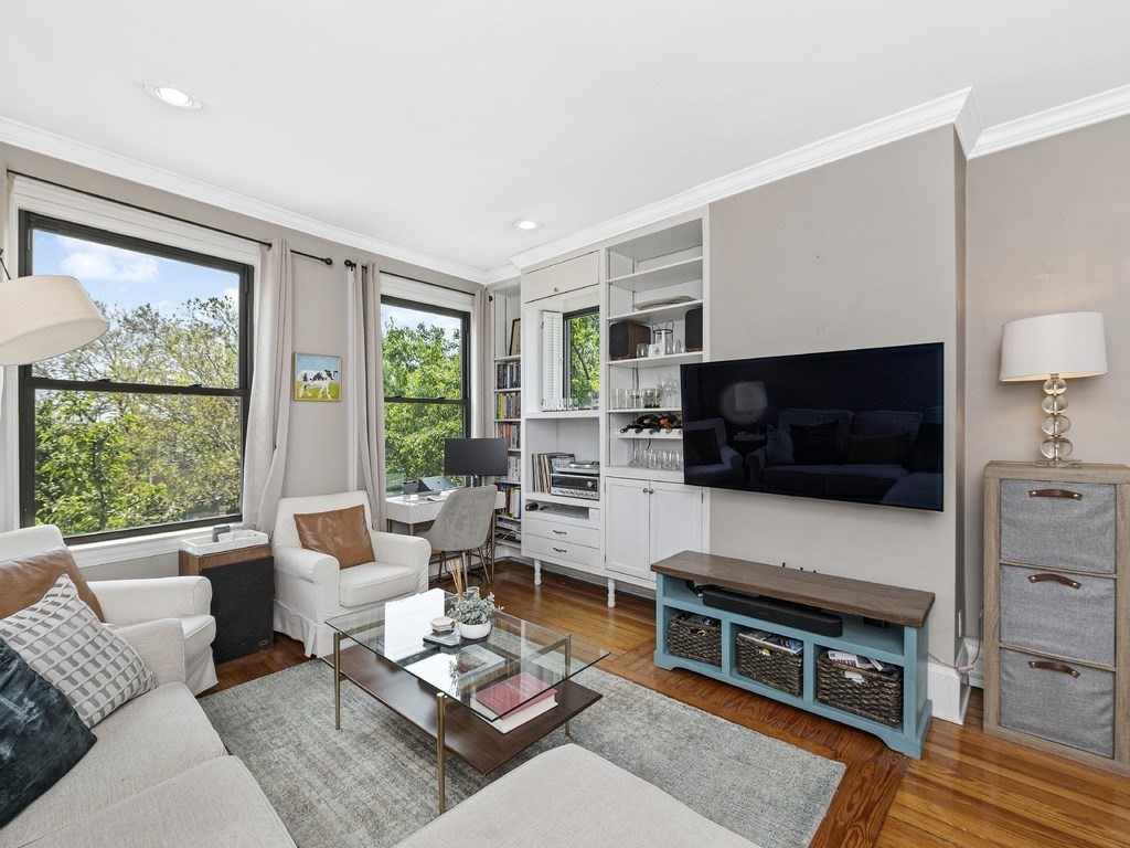 58 Winthrop Street, Unit 3 Boston, MA 02129 - Photo 2 of 14 a living room with furniture a flat screen tv and a fireplace