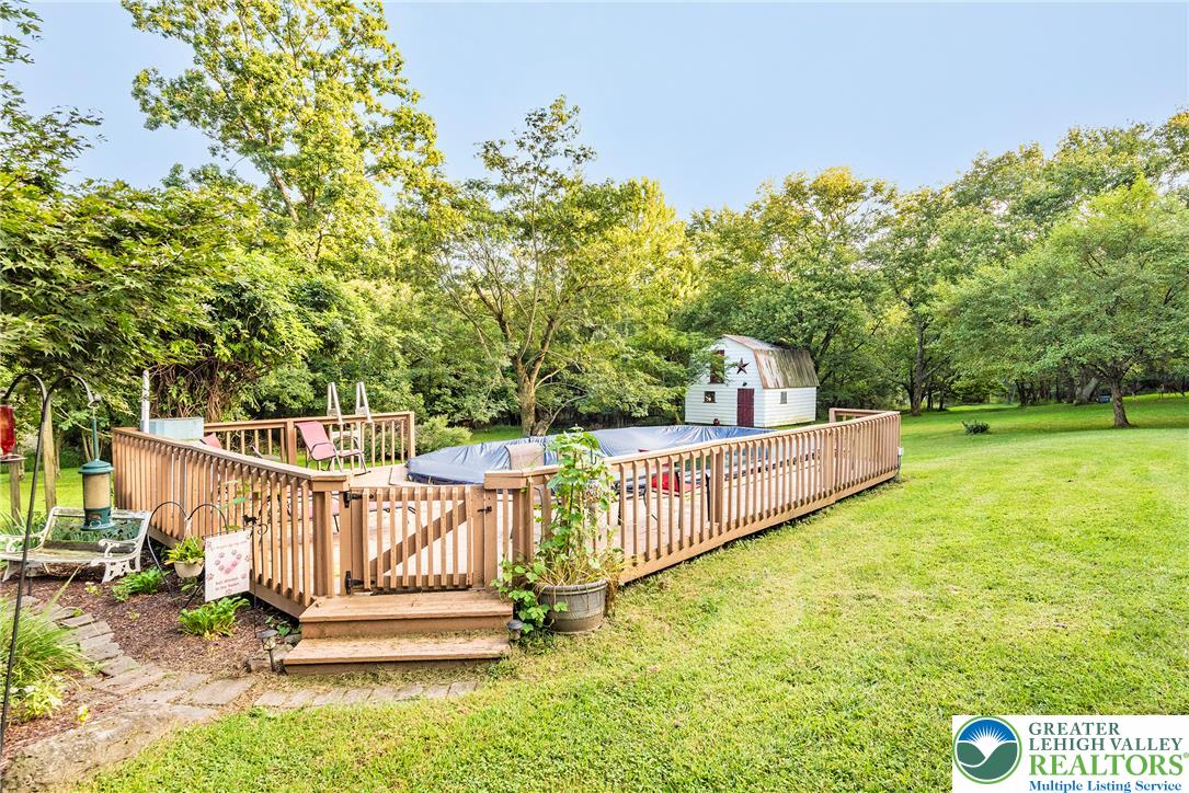 1114 Fox Gap Road Bangor, PA 18013 - Photo 8 of 63 A spacious grassy lawn surrounds the fenced wooden deck and detached backyard storage shed.
