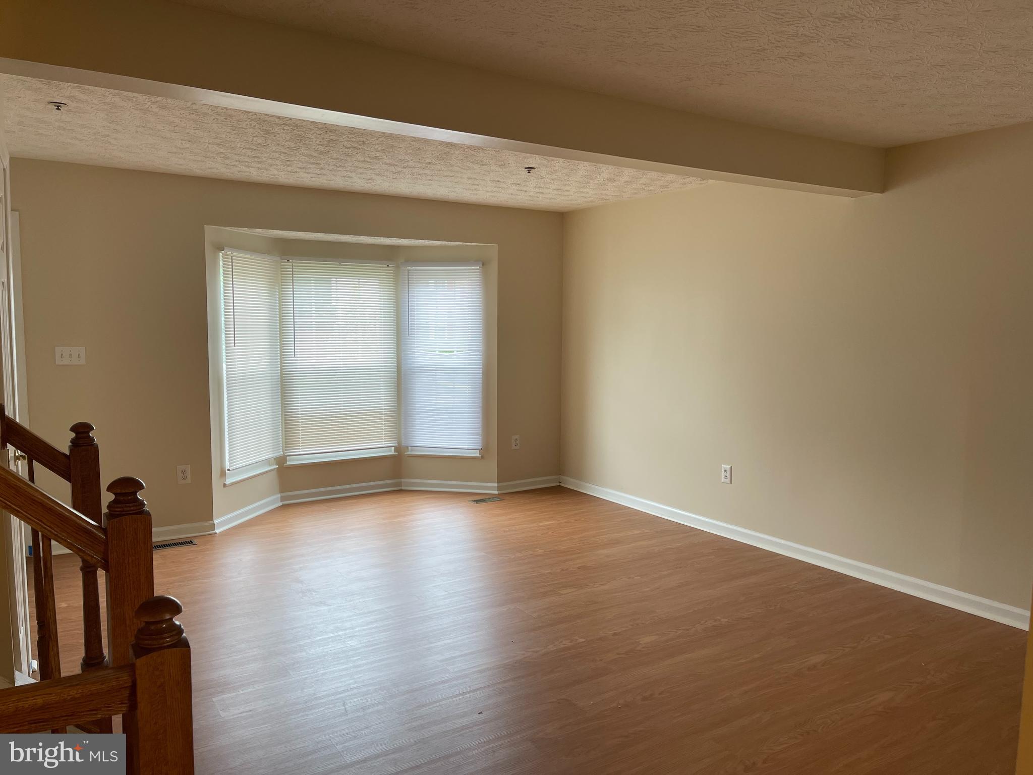 147 Foxview Drive Glen Burnie, MD 21061 - Photo 4 of 12 an empty room with wooden floor and windows