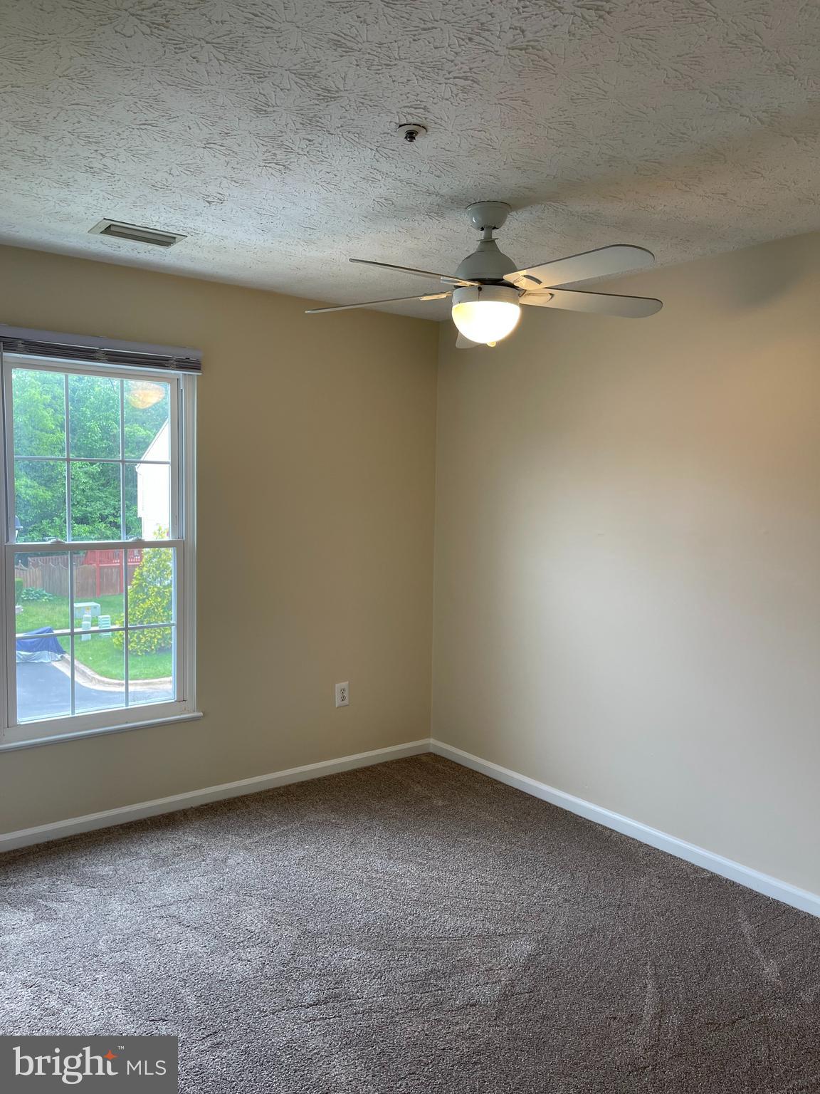 147 Foxview Drive Glen Burnie, MD 21061 - Photo 8 of 12 an empty room with a window and ceiling fan