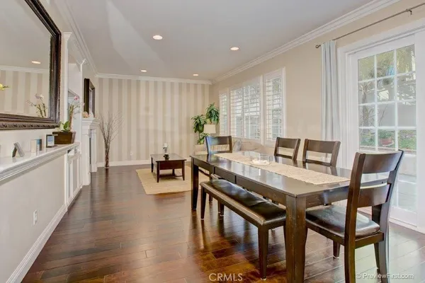 a view of a dining room with furniture and wooden floor