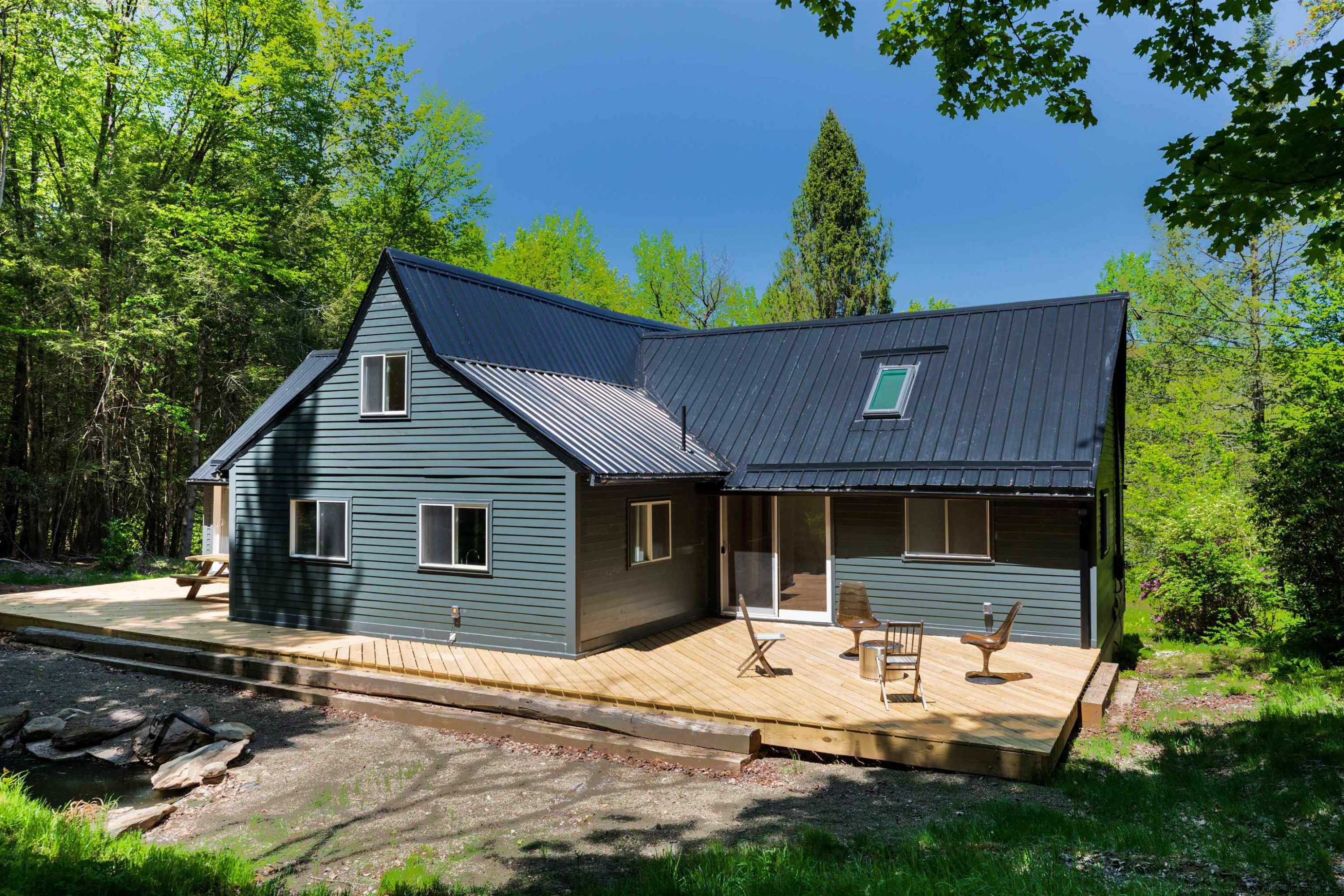 356 Mink Brook Road Colchester, NY 13755 - Photo 16 of 25 a view of a house with backyard and sitting area