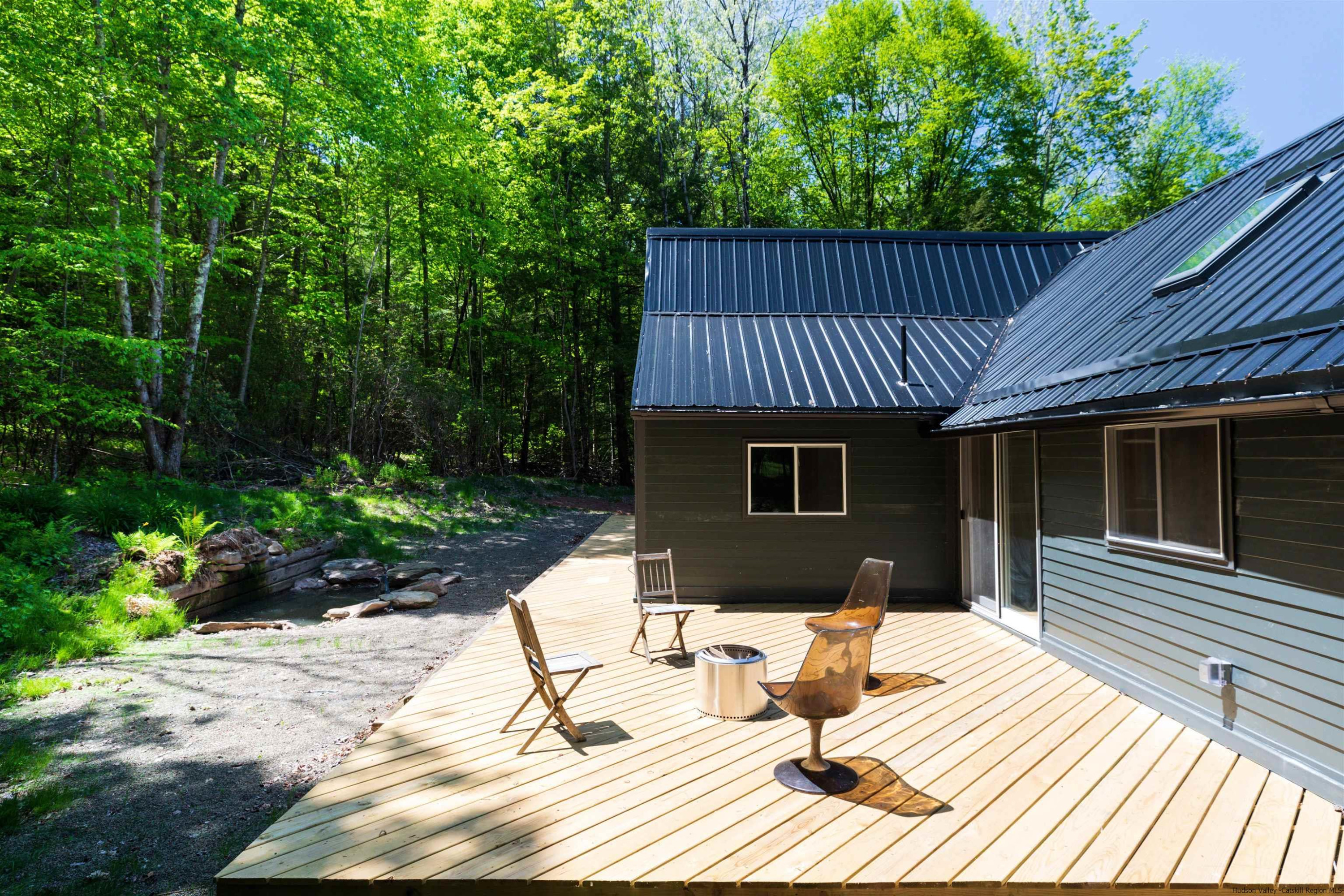 356 Mink Brook Road Colchester, NY 13755 - Photo 17 of 25 a view of a house with a patio