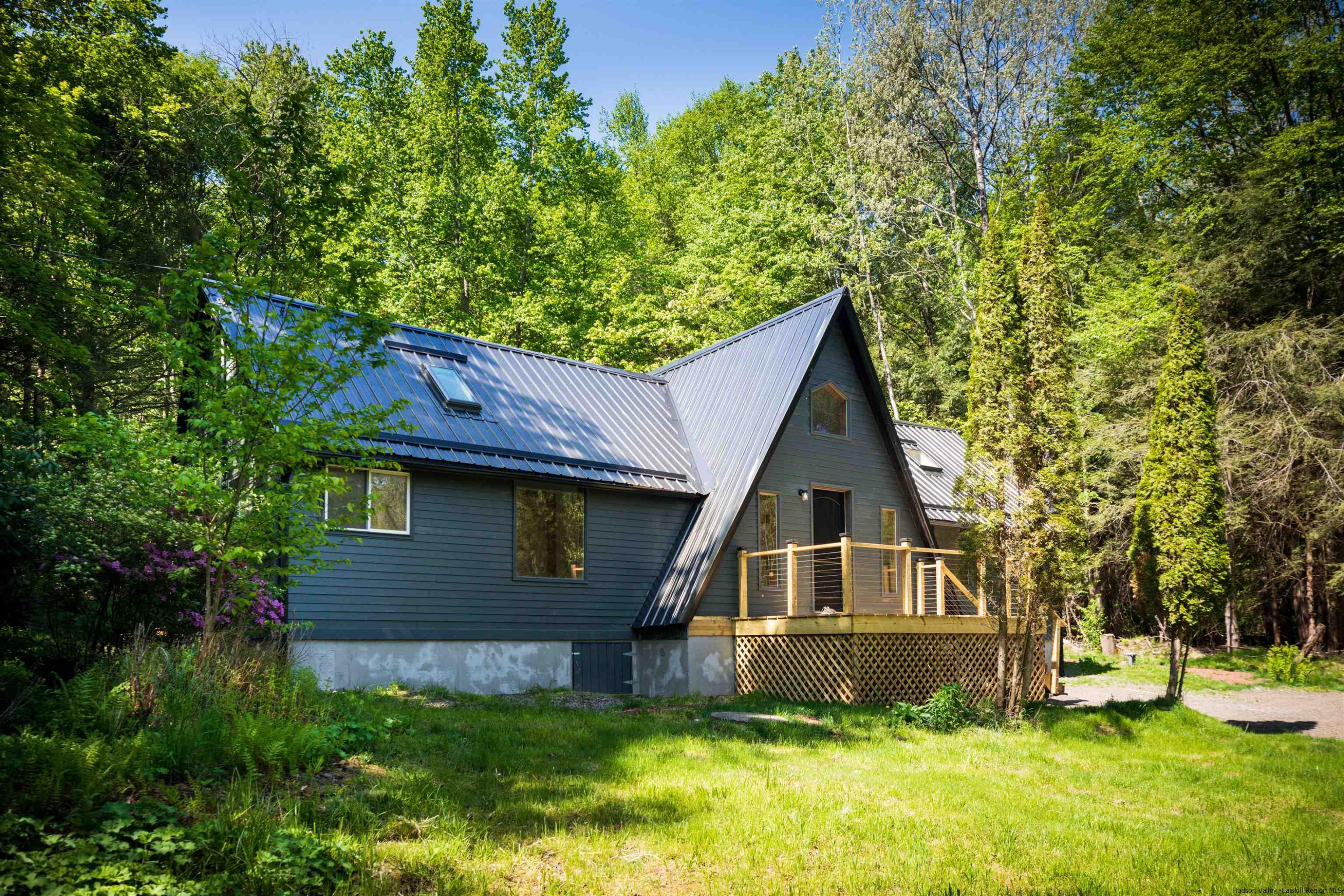 356 Mink Brook Road Colchester, NY 13755 - Photo 19 of 25 a front view of a house with a yard and trees