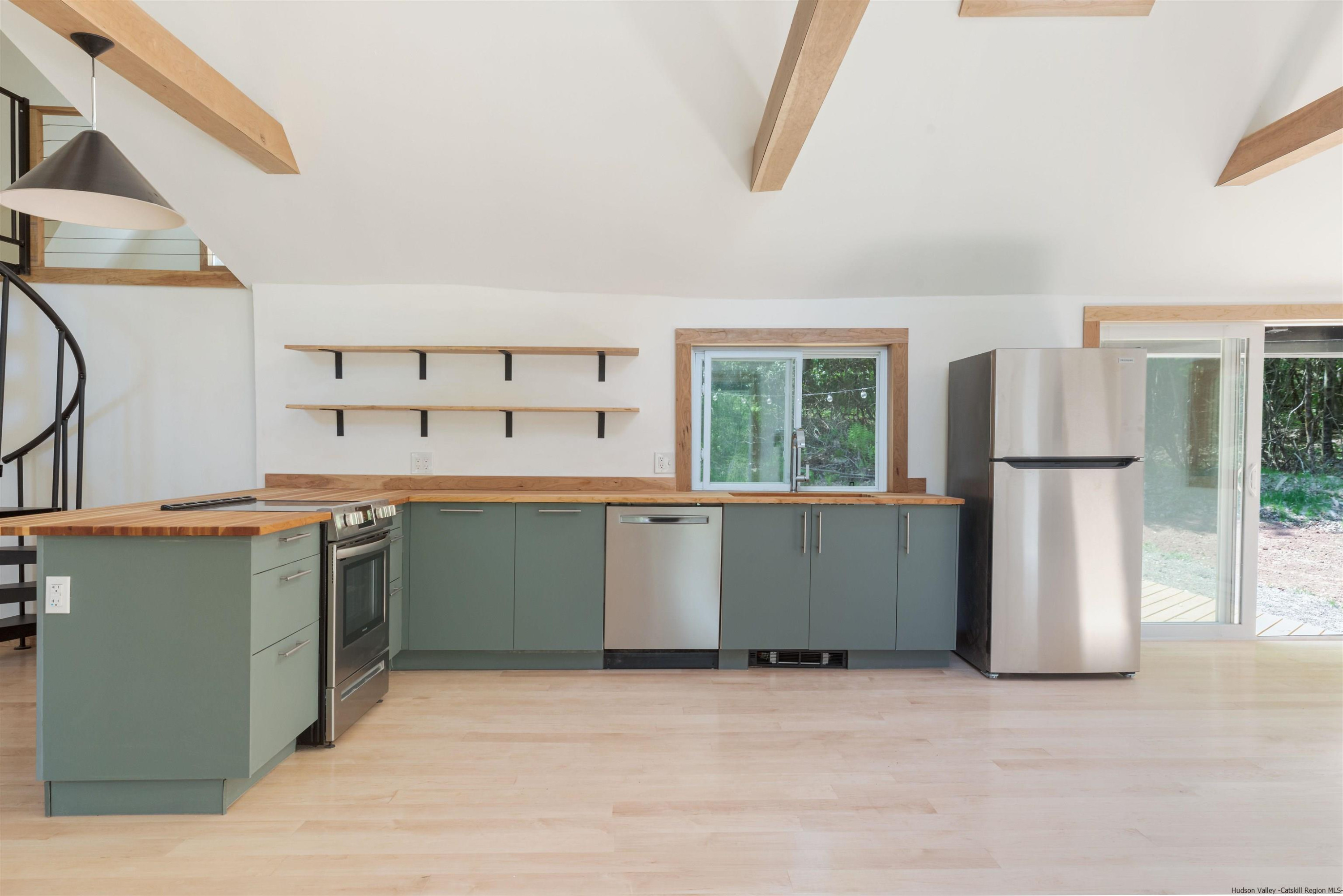 356 Mink Brook Road Colchester, NY 13755 - Photo 6 of 25 a kitchen with a refrigerator and a sink