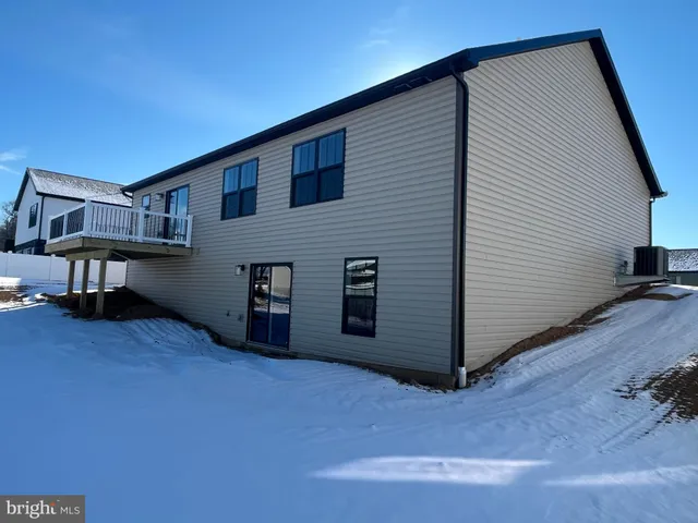a view of a house with a wooden deck