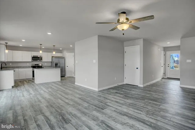 a kitchen with stainless steel appliances a refrigerator sink and cabinets