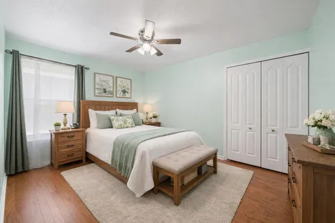 a spacious bedroom with a bed and a chandelier