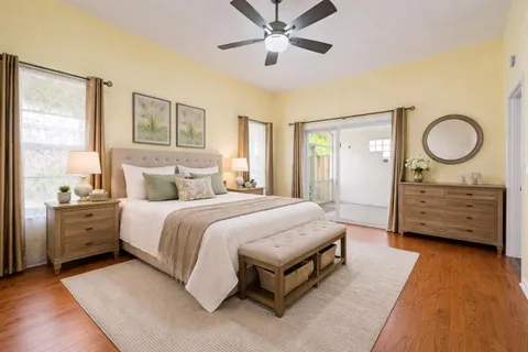 a spacious bedroom with a bed and cabinet