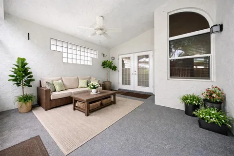 a living room with furniture potted plant and a window