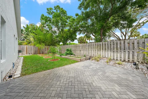 a view of a yard with wooden fence