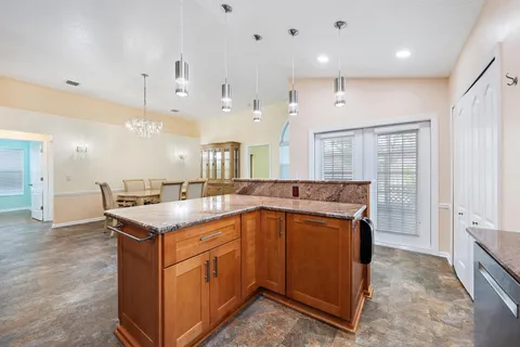 a kitchen with a sink a counter top space and stainless steel appliances