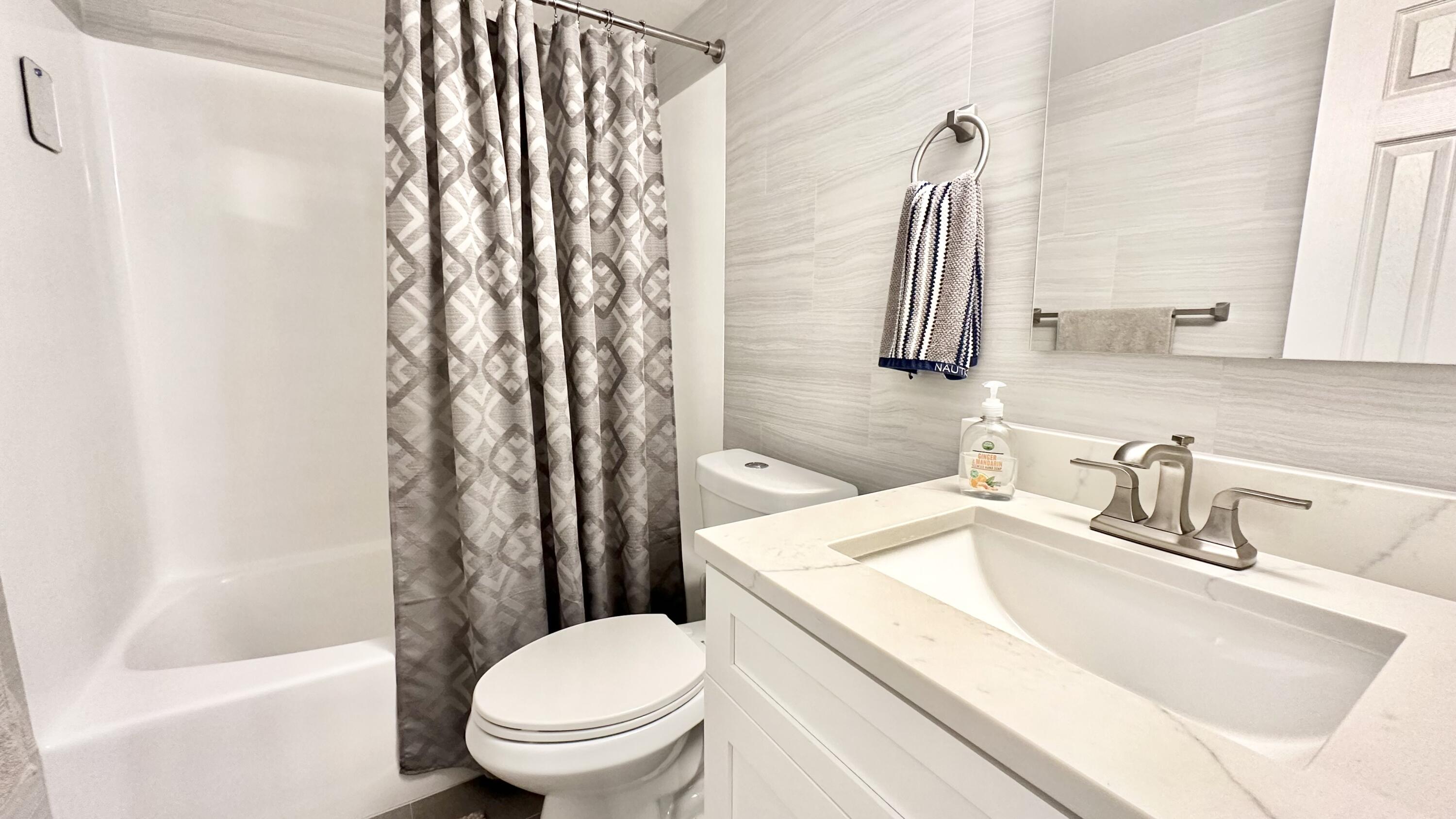 154 Lake Meryl Drive, Unit 257 West Palm Beach, FL 33411 - Photo 11 of 25 a bathroom with a sink toilet and shower