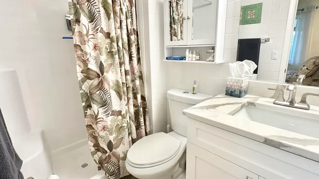 a bathroom with a sink toilet and shower