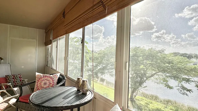 a living room with furniture and a floor to ceiling window