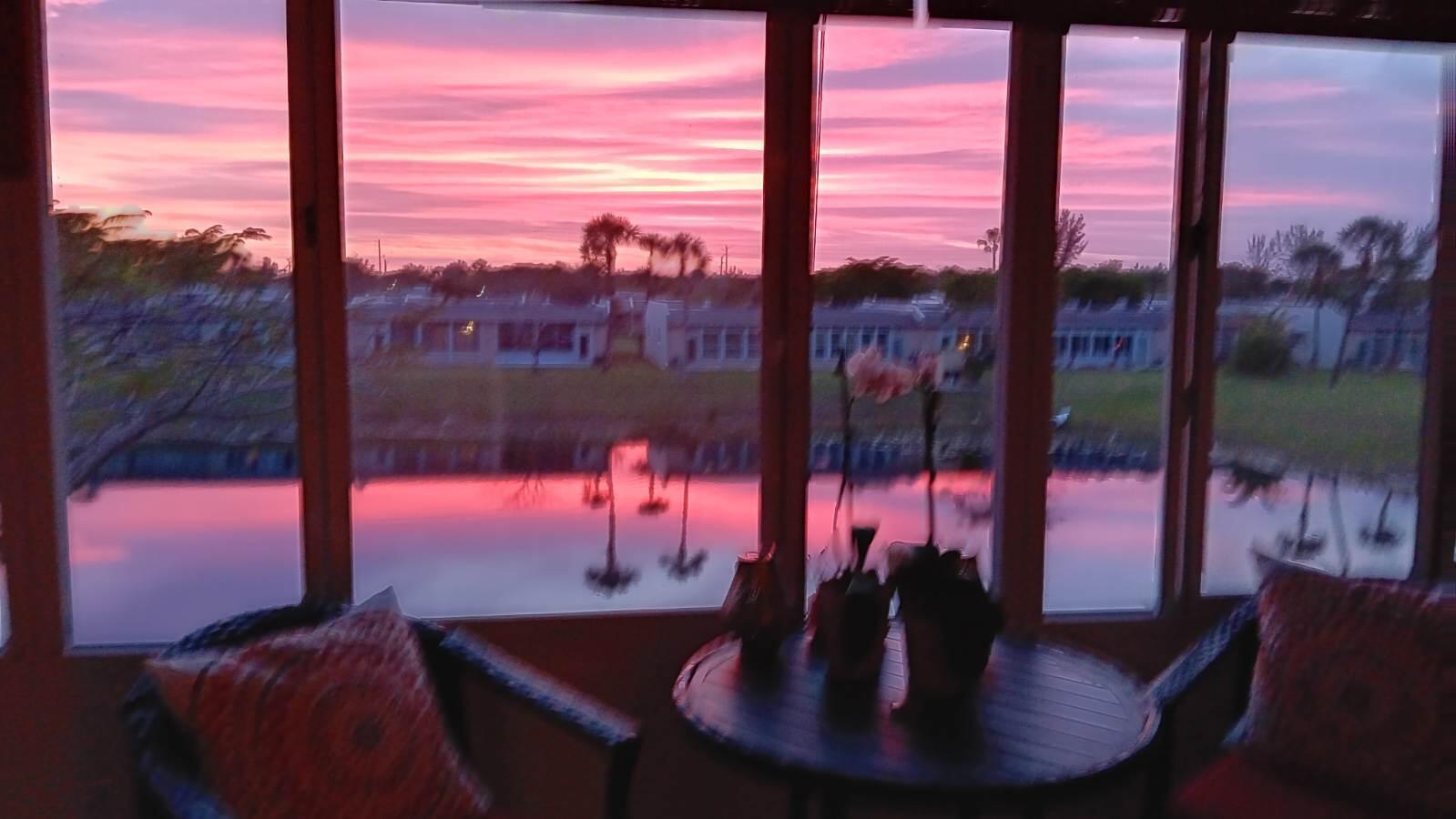154 Lake Meryl Drive, Unit 257 West Palm Beach, FL 33411 - Photo 22 of 25 a view of a balcony with dining table and chairs