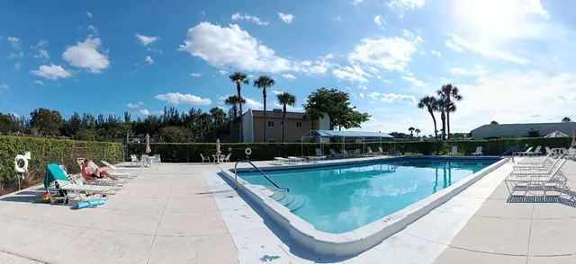 a view of a swimming pool with a lounge chairs