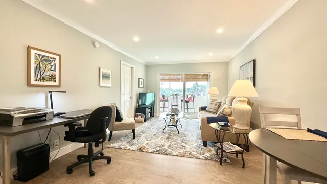 a view of a workspace with furniture and a window