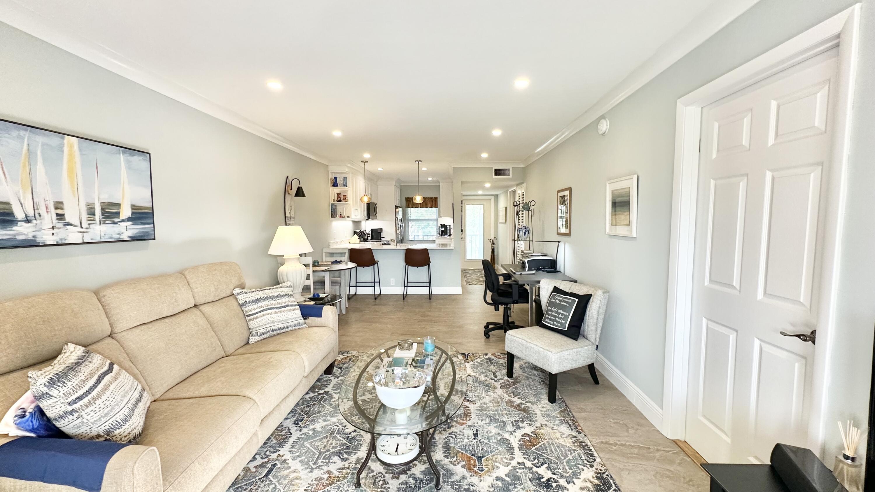 154 Lake Meryl Drive, Unit 257 West Palm Beach, FL 33411 - Photo 9 of 25 a living room with furniture and a couch