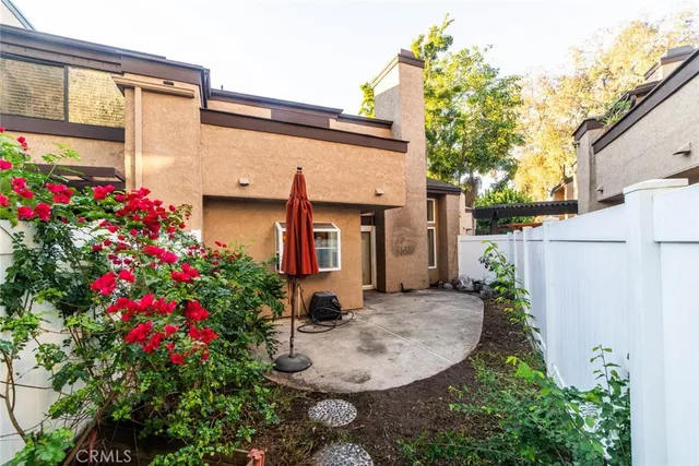 a view of a chair and table in backyard