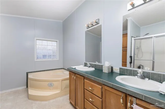 a bathroom with a granite countertop sink a mirror and a bathtub