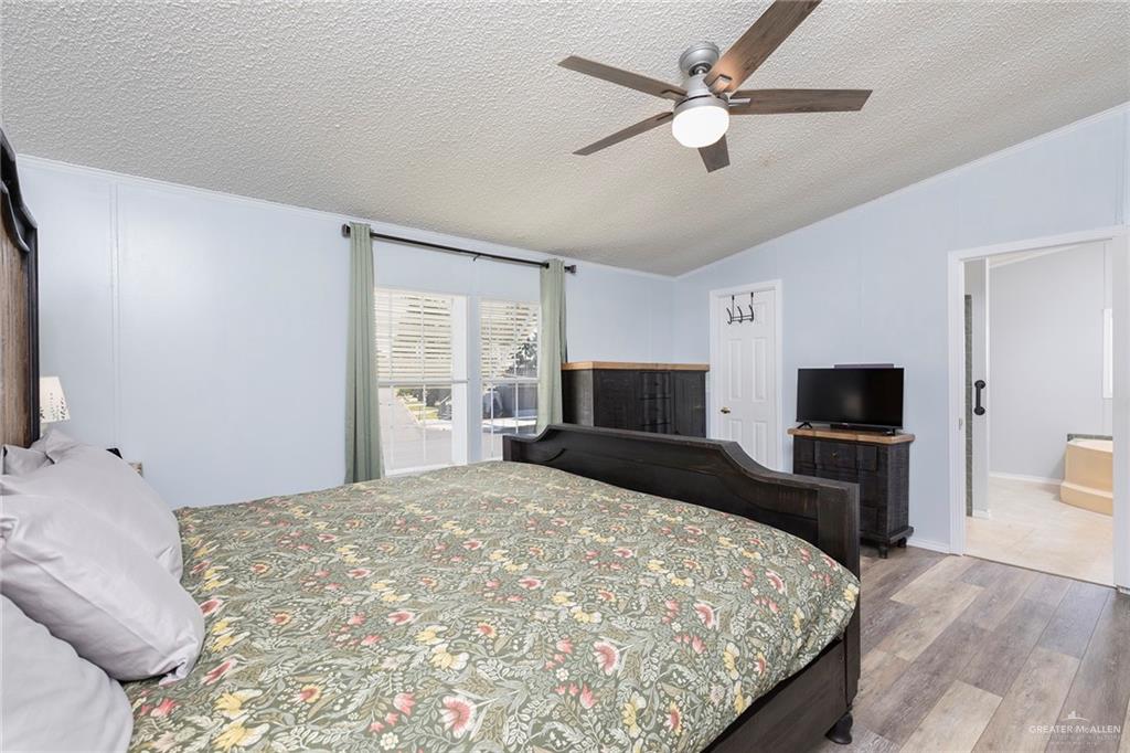 1034 Santa Maria Street Mercedes, TX 78570 - Photo 17 of 25 a bedroom with a bed and a flat screen tv