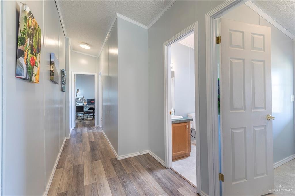 1034 Santa Maria Street Mercedes, TX 78570 - Photo 18 of 25 a view of a hallway with wooden floor