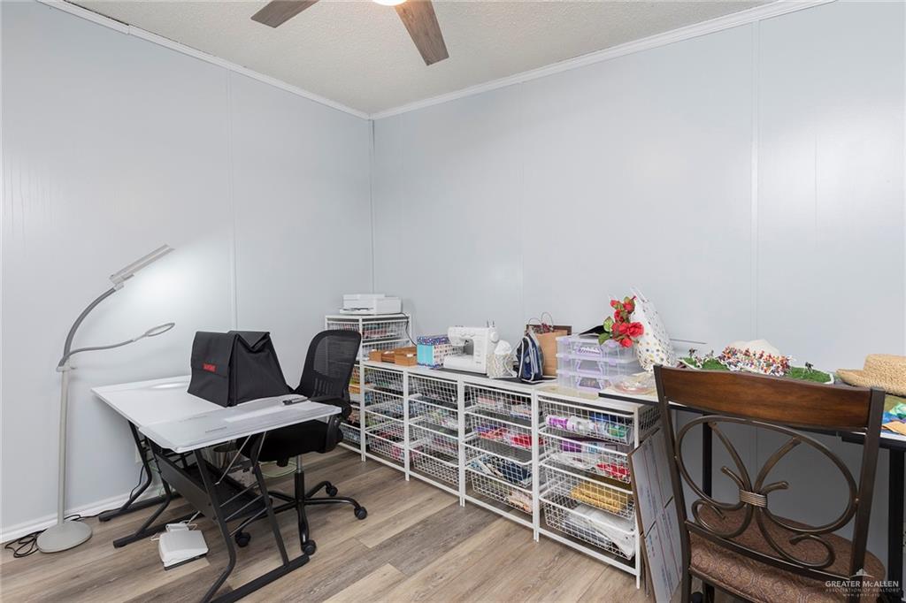 1034 Santa Maria Street Mercedes, TX 78570 - Photo 19 of 25 a workspace with furniture and wooden floor