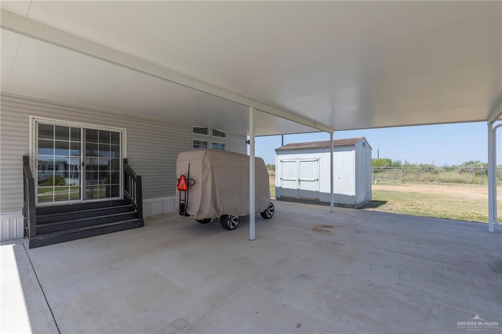 1034 Santa Maria Street Mercedes, TX 78570 - Photo 23 of 25 a view of a room with wooden floor and windows
