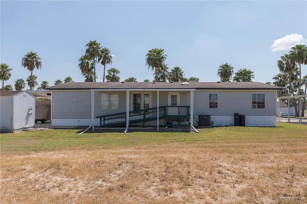 1034 Santa Maria Street Mercedes, TX 78570 - Photo 24 of 25 a view of a house with pool and a yard