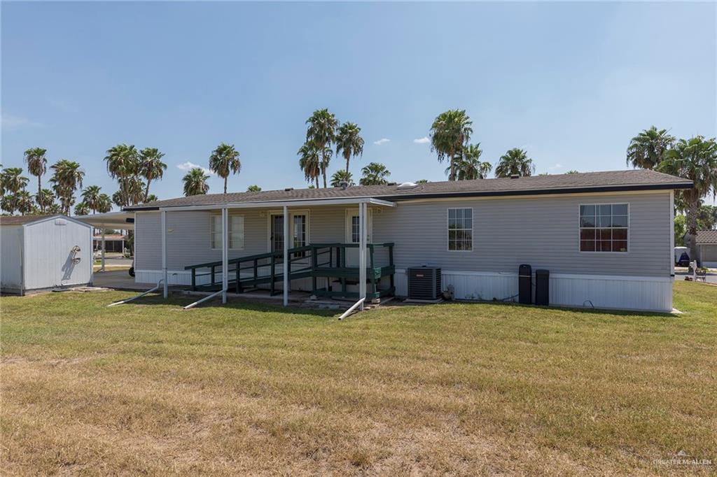 1034 Santa Maria Street Mercedes, TX 78570 - Photo 25 of 25 a view of a house with a yard and a garage