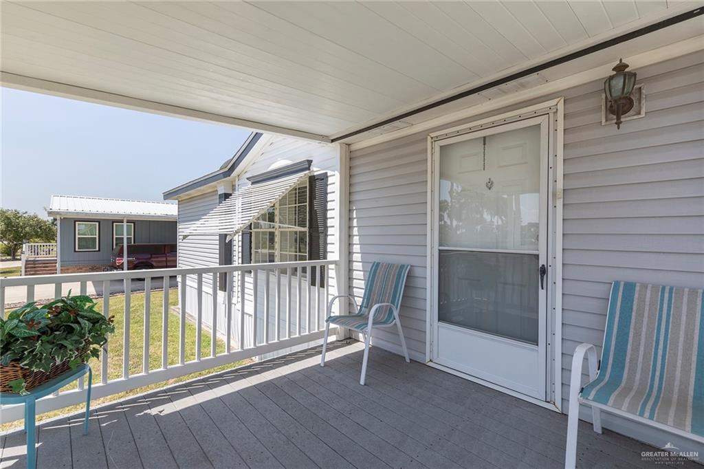 1034 Santa Maria Street Mercedes, TX 78570 - Photo 3 of 25 a view of a house with porch and wooden floor