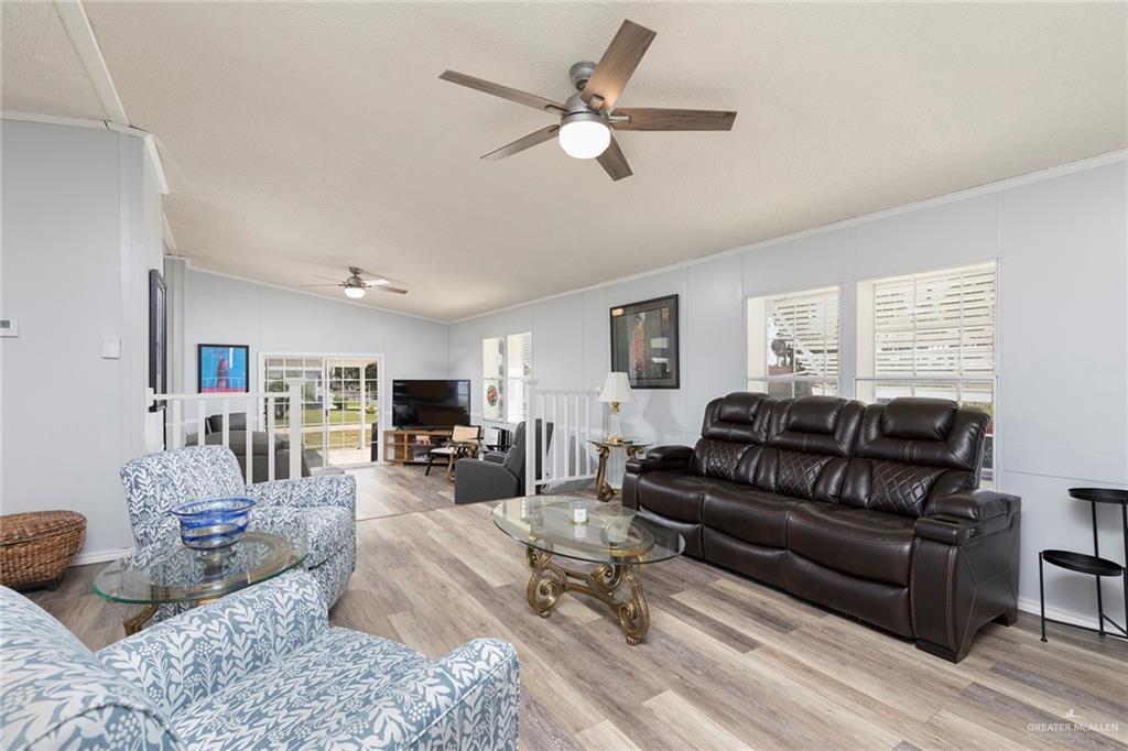1034 Santa Maria Street Mercedes, TX 78570 - Photo 6 of 25 a living room with furniture a flat screen tv and a window