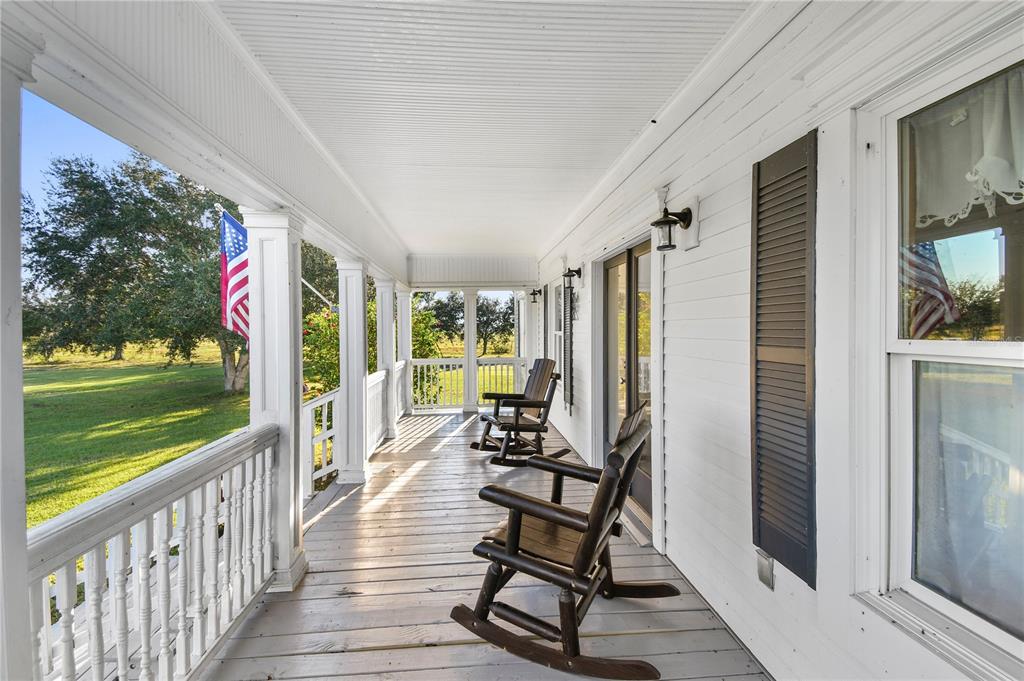 10807 Northwest Lily County Line Road Ona, FL 33865 - Photo 34 of 91 a view of a porch with wooden floor outdoor seating and yard