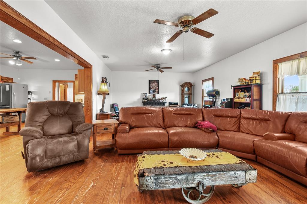 10807 Northwest Lily County Line Road Ona, FL 33865 - Photo 39 of 91 a living room with furniture a ceiling fan and a rug