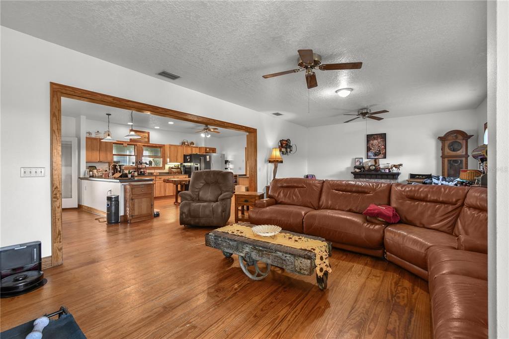 10807 Northwest Lily County Line Road Ona, FL 33865 - Photo 40 of 91 a living room with furniture and kitchen view