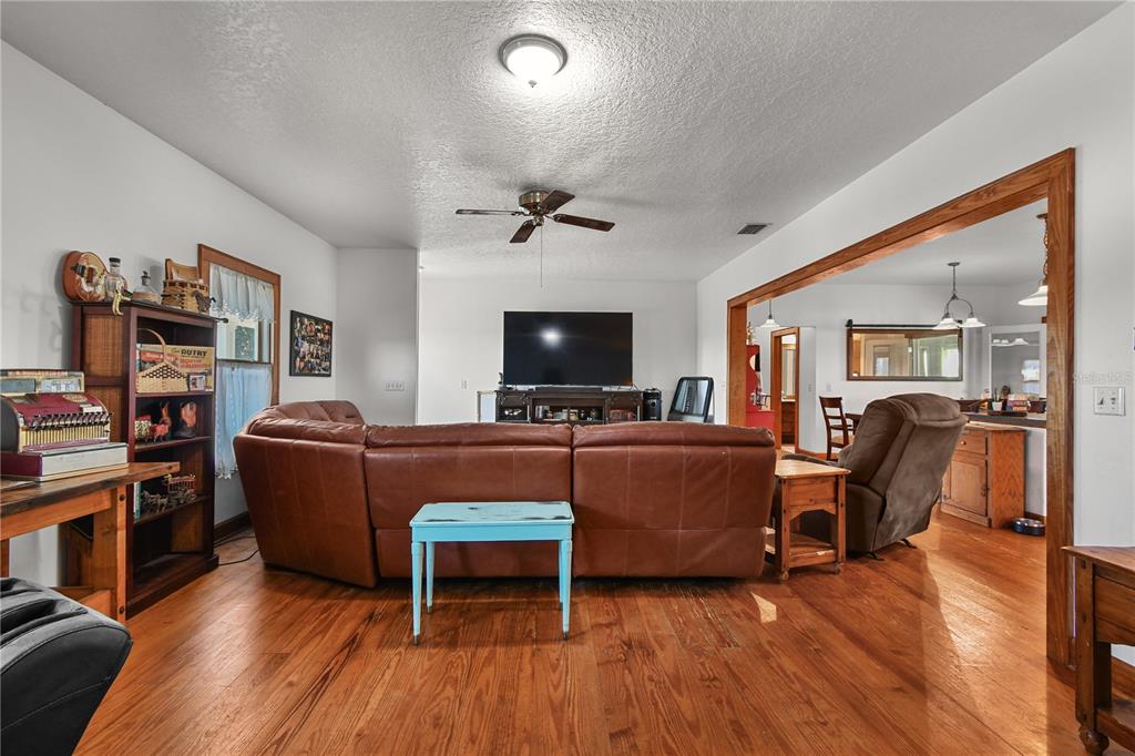 10807 Northwest Lily County Line Road Ona, FL 33865 - Photo 43 of 91 a living room with furniture and a flat screen tv