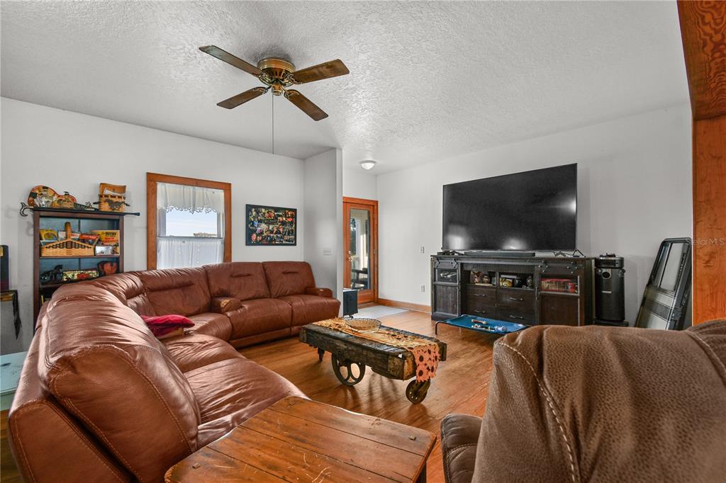 10807 Northwest Lily County Line Road Ona, FL 33865 - Photo 44 of 91 a living room with furniture and a flat screen tv
