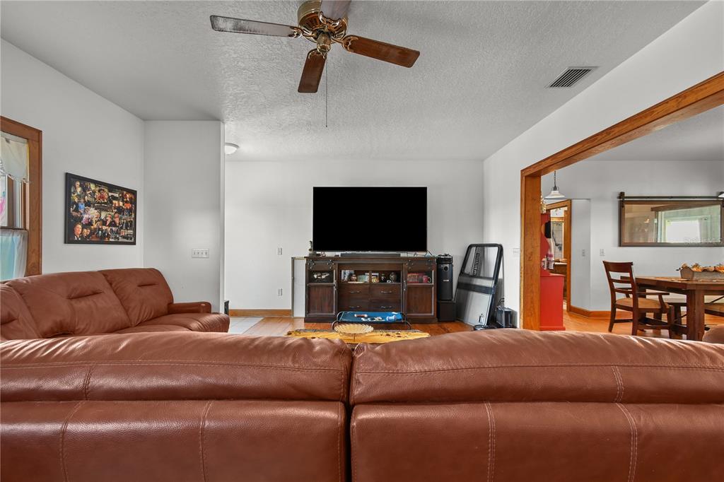 10807 Northwest Lily County Line Road Ona, FL 33865 - Photo 45 of 91 a living room with furniture and a flat screen tv